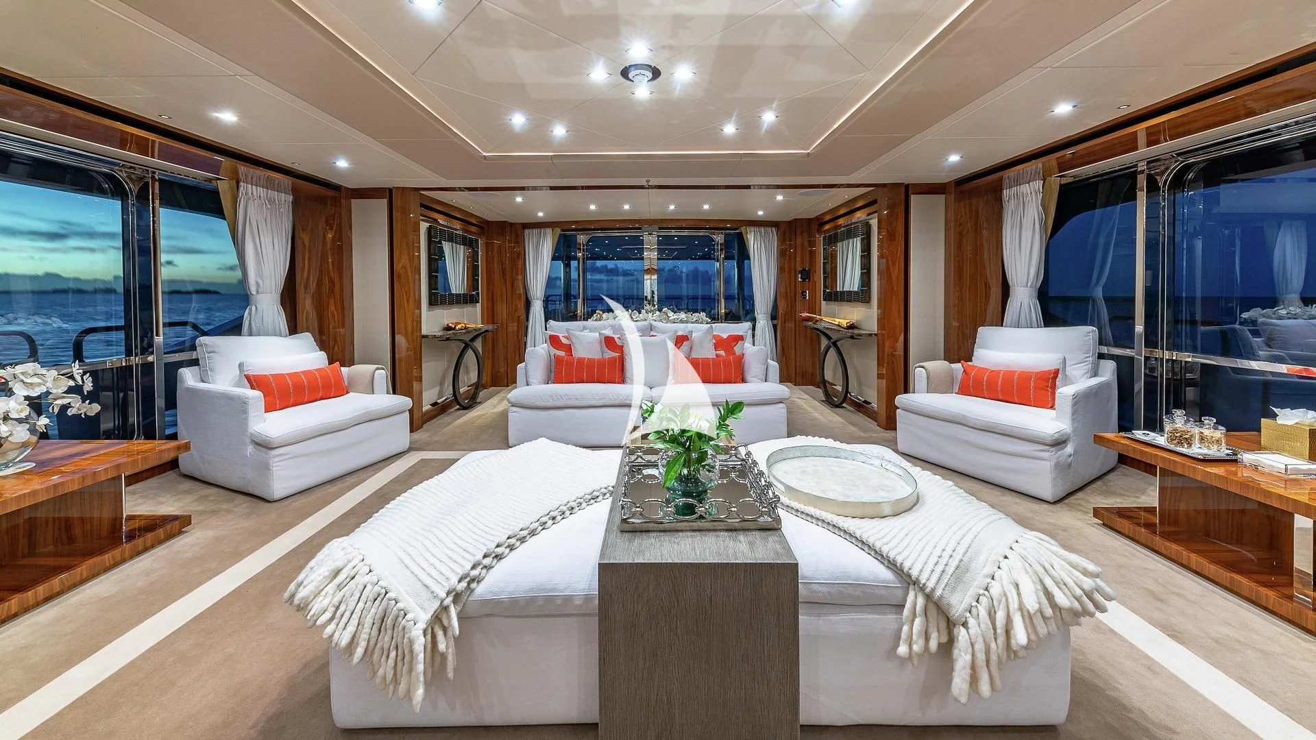 a large room with a large white bed and a large white table aboard ALESSANDRA III Yacht for Charter