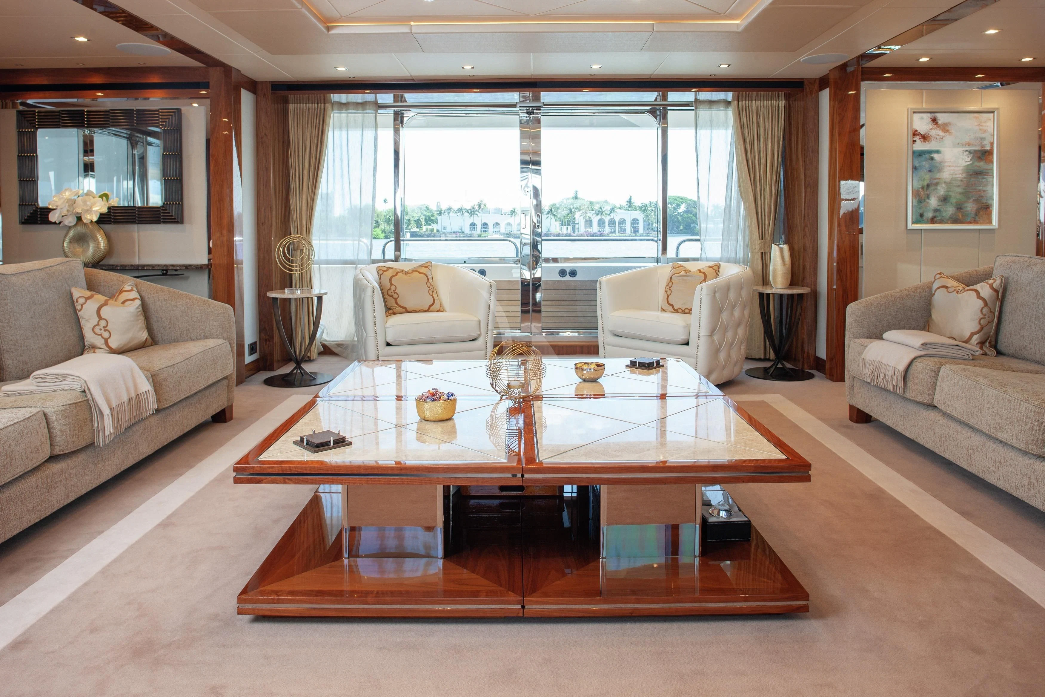 a living room with a table and couches aboard ALESSANDRA III Yacht for Charter