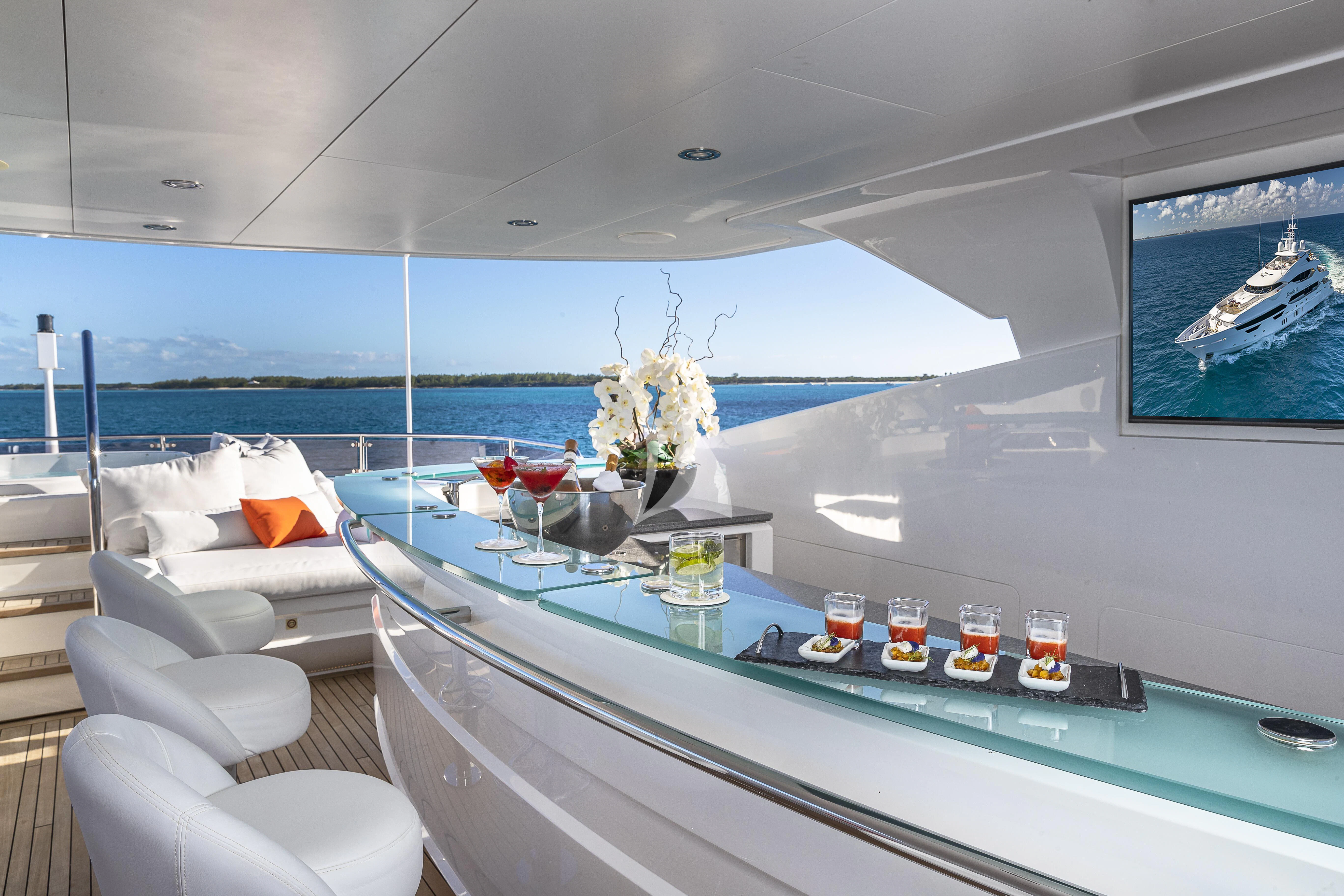 a boat with drinks and a table aboard ALESSANDRA III Yacht for Charter