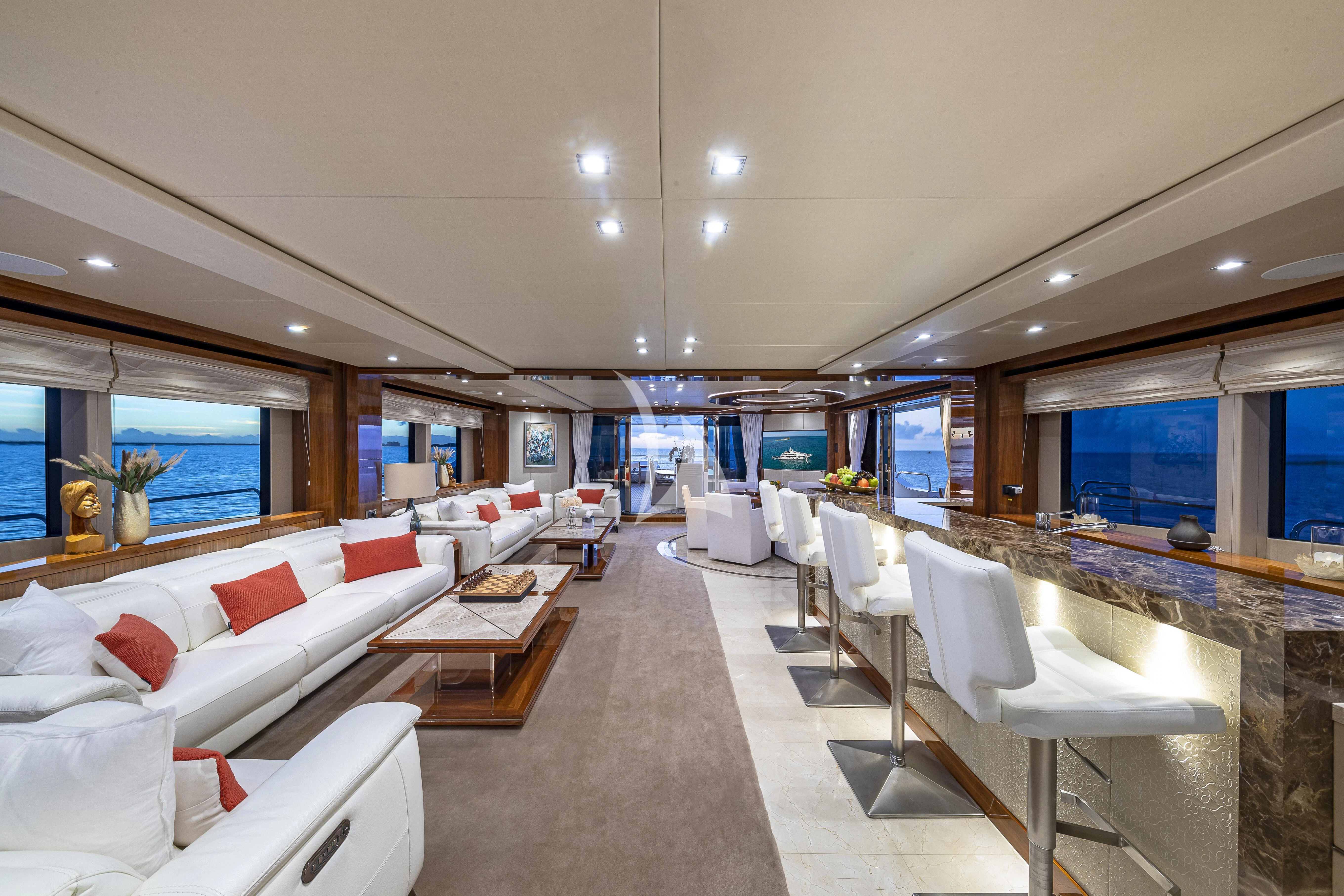 a room with a table chairs and a couch aboard ALESSANDRA III Yacht for Charter