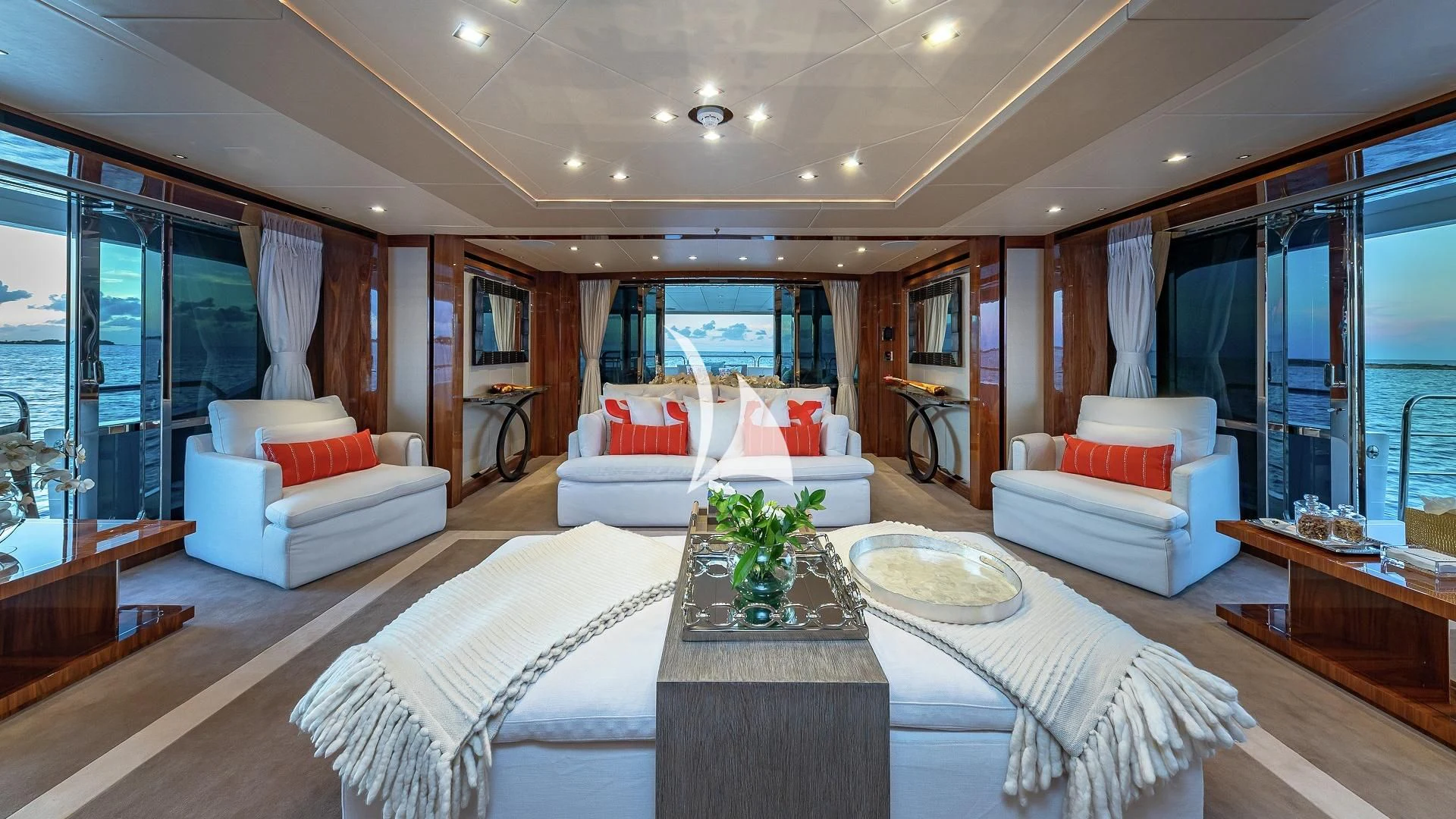 a large living room with a large white bed and a large window aboard ALESSANDRA III Yacht for Charter