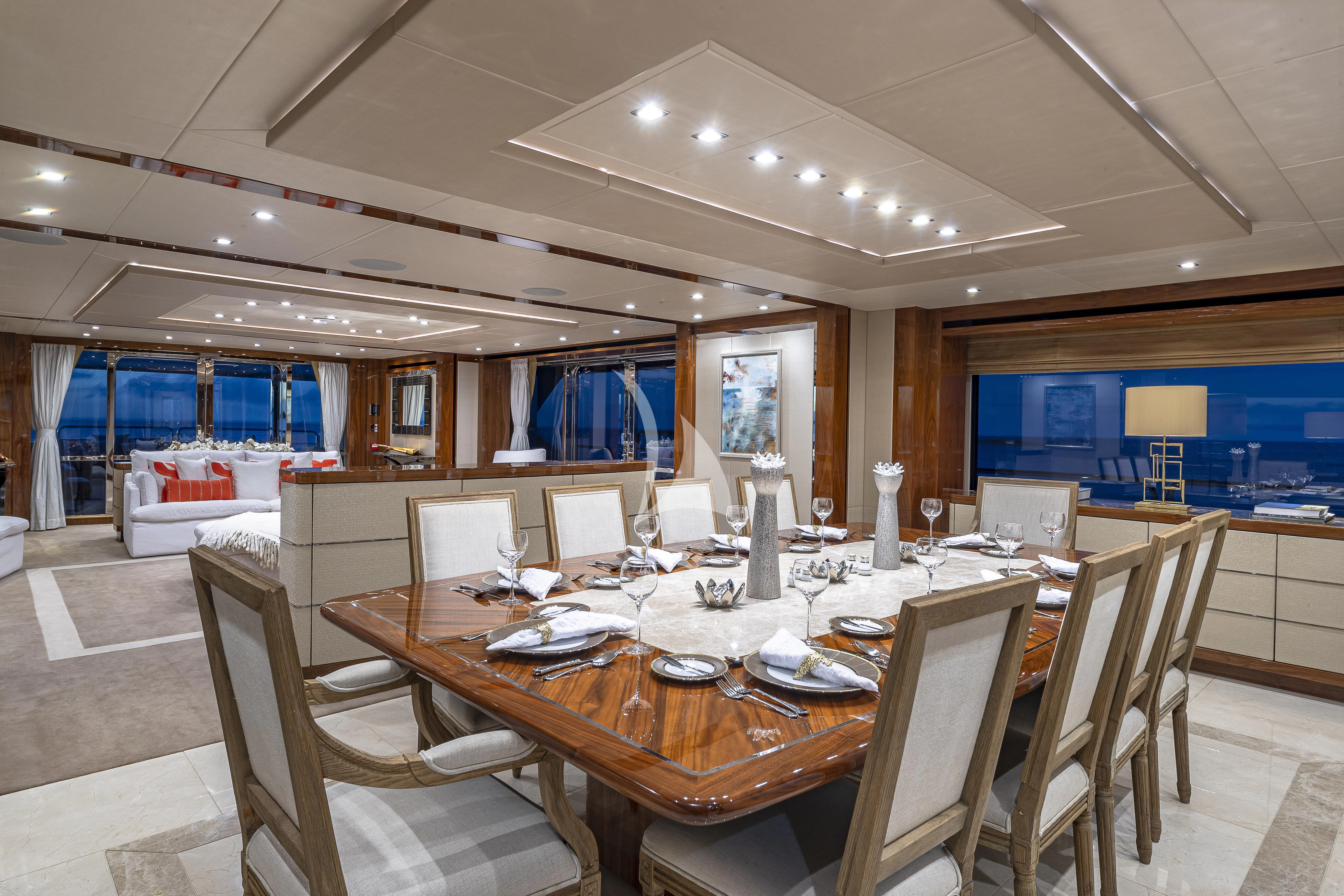 a large room with tables and chairs aboard ALESSANDRA III Yacht for Charter