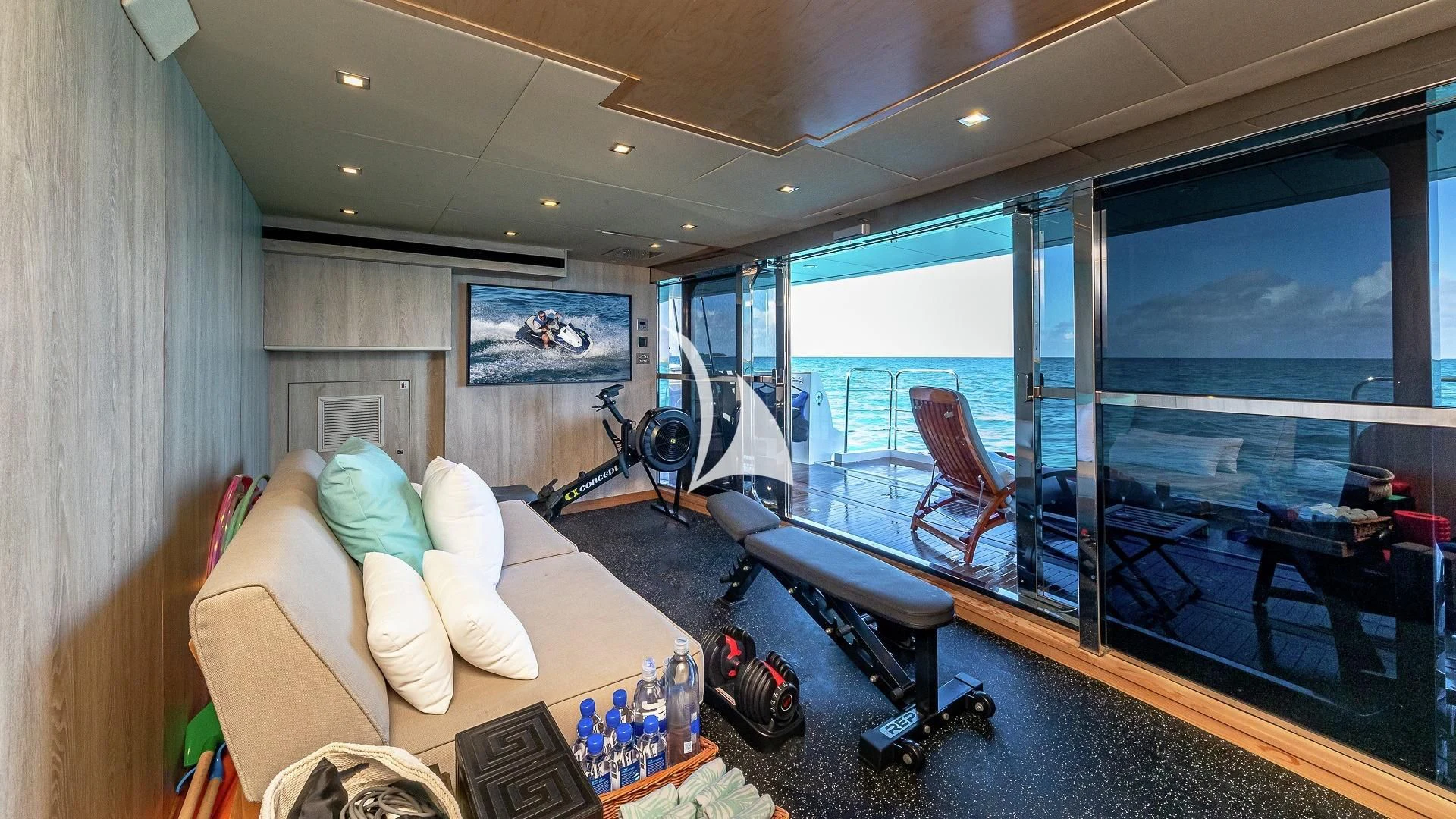 a room with a large window and a table with chairs and a large window aboard ALESSANDRA III Yacht for Charter