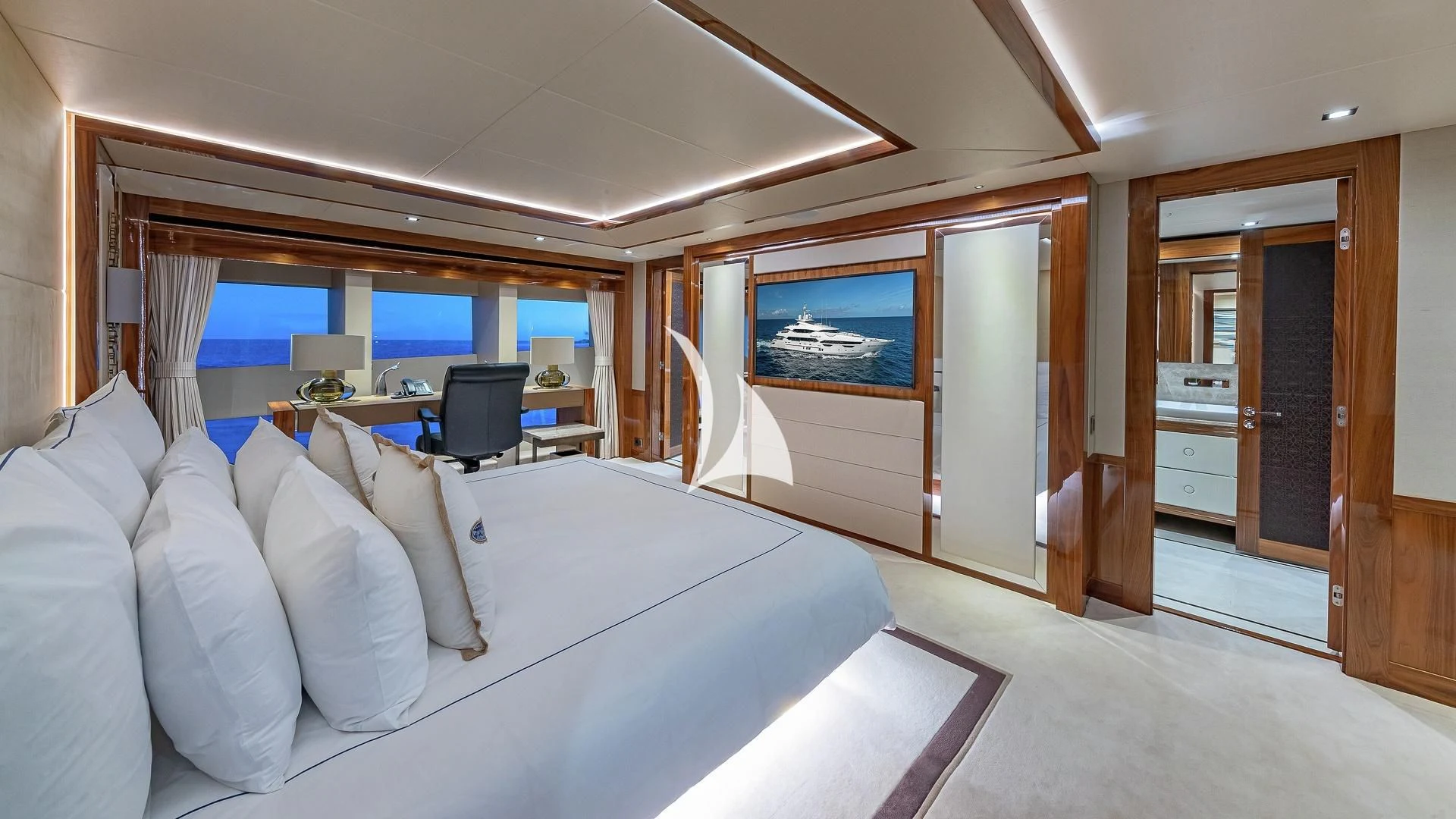 a room with a bed and a desk aboard ALESSANDRA III Yacht for Charter