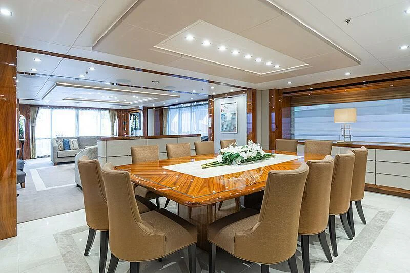 a large room with a table and chairs aboard ALESSANDRA III Yacht for Charter