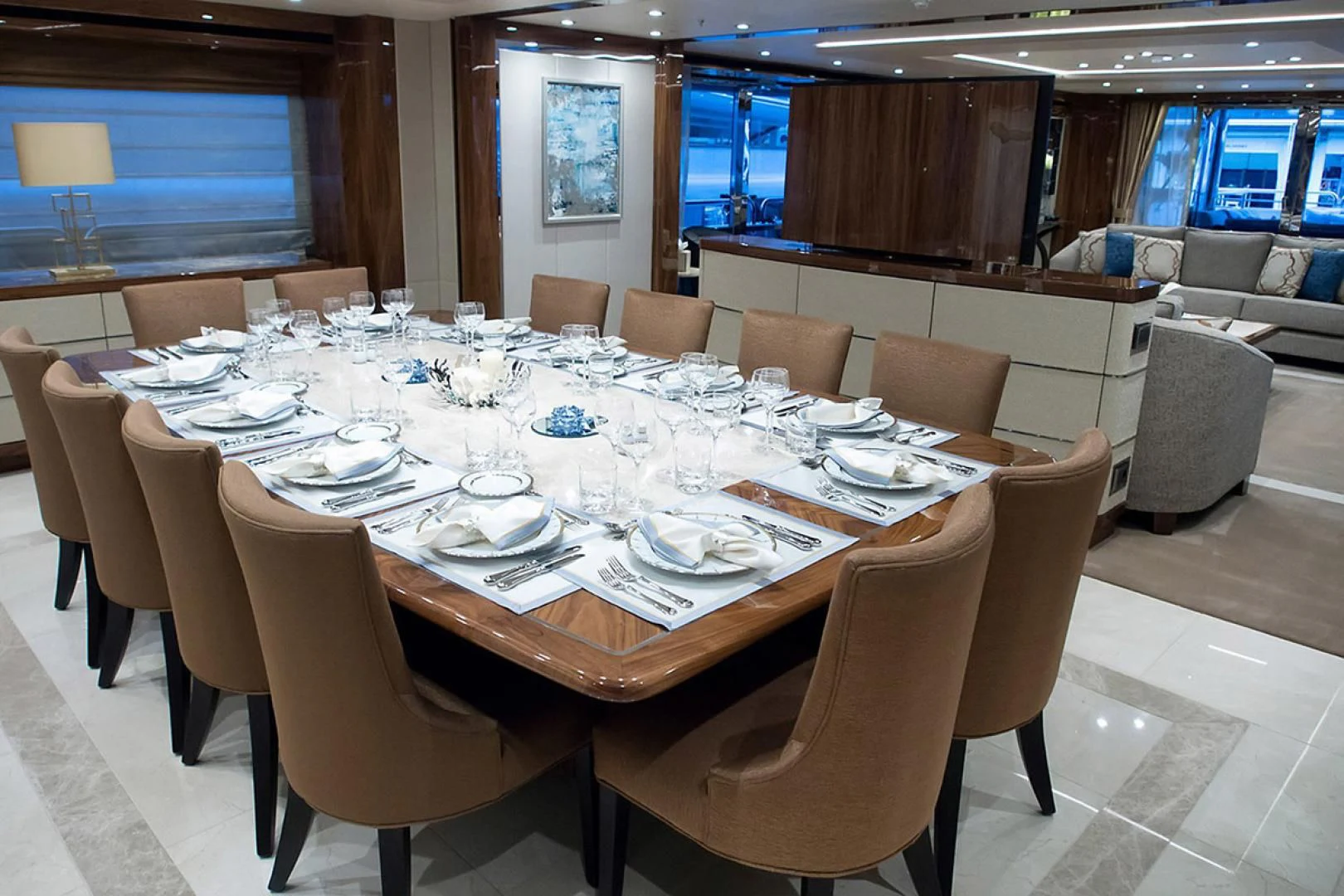 a large dining room with a table set for a dinner aboard ALESSANDRA III Yacht for Charter