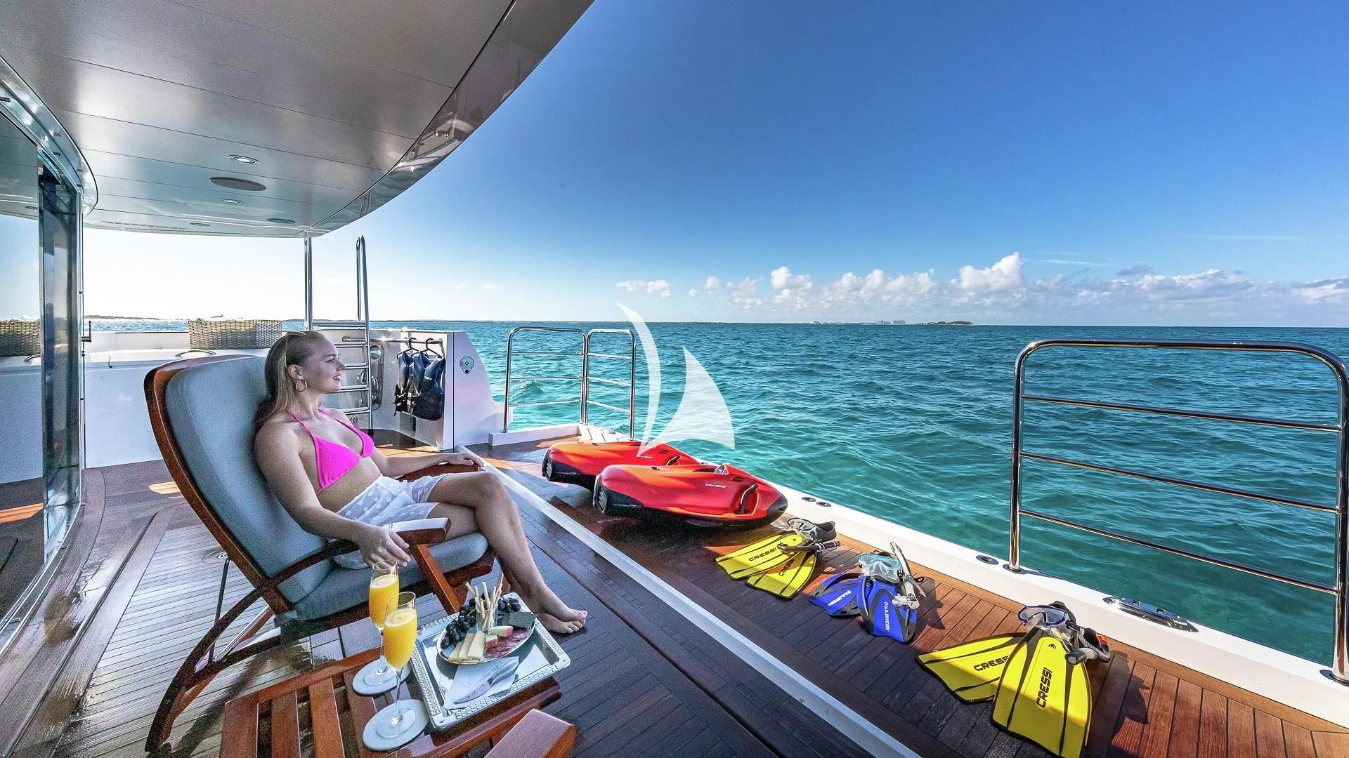 a person sitting on a deck on a boat aboard ALESSANDRA III Yacht for Charter
