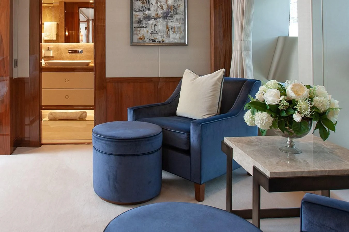 a blue couch and a table in a room aboard ALESSANDRA III Yacht for Charter