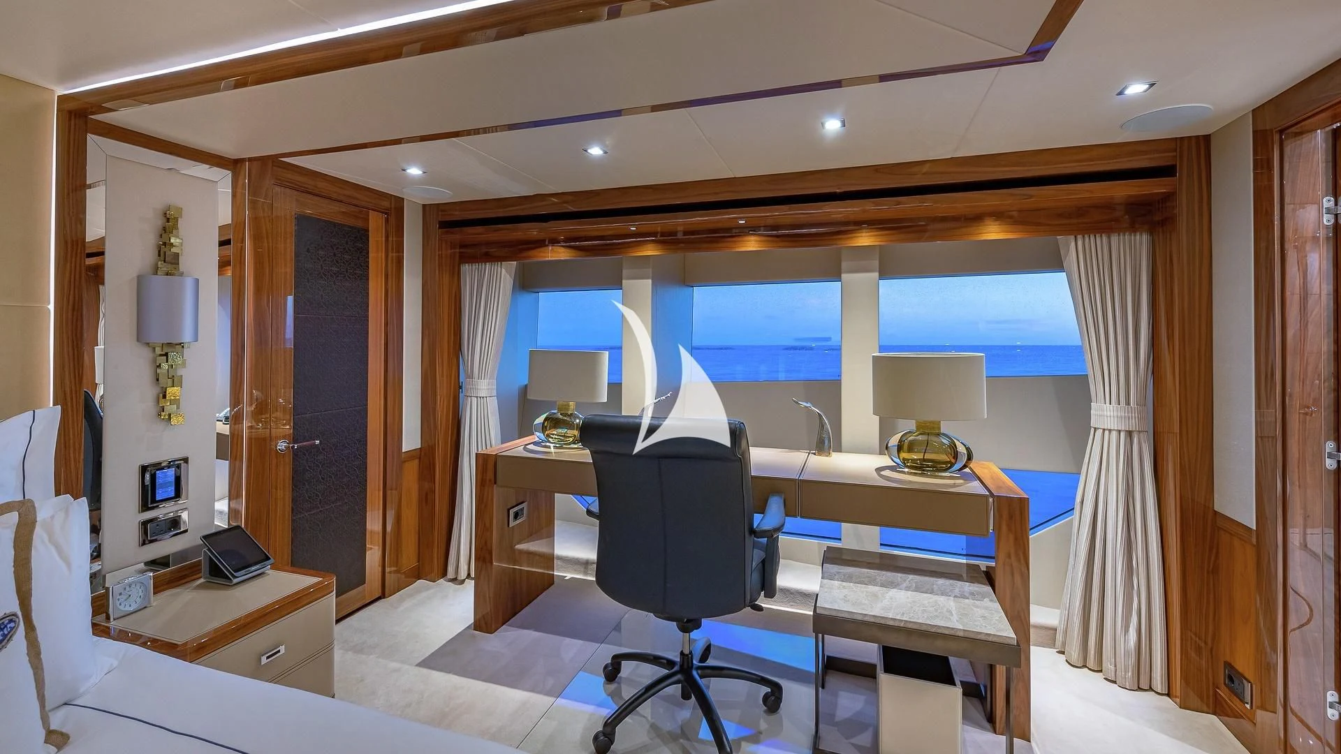 a room with a bed and desk aboard ALESSANDRA III Yacht for Charter