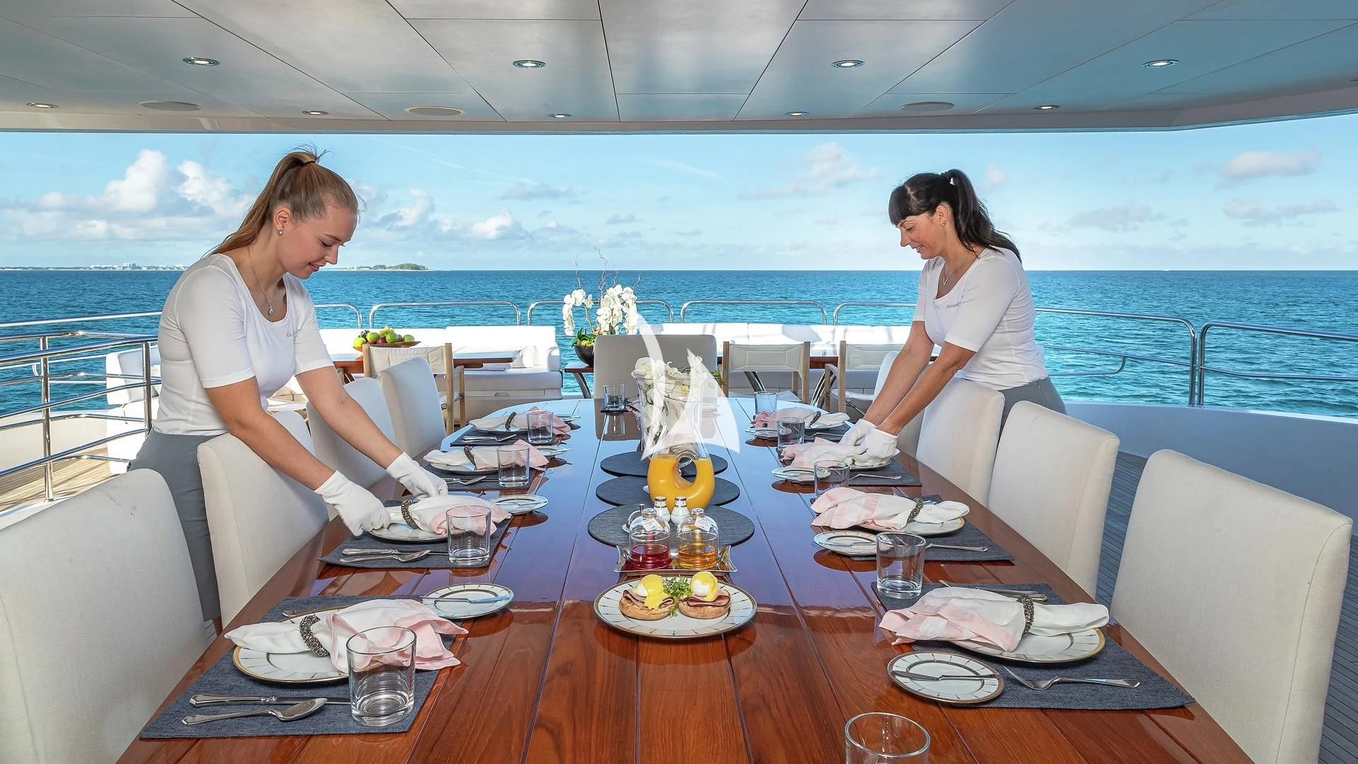 a couple of women sitting at a table with food on it aboard ALESSANDRA III Yacht for Charter