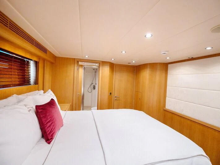a room with a bed and a mirror aboard BANDIDO I Yacht for Sale