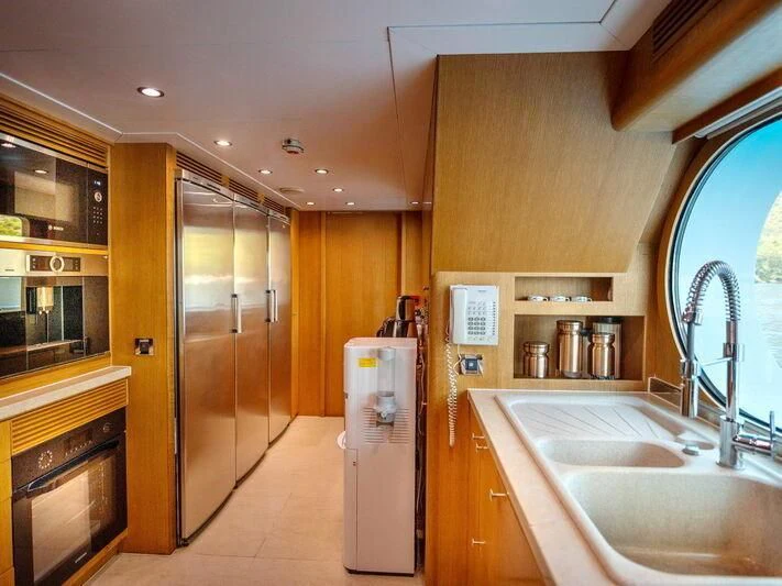a kitchen with a refrigerator and sink aboard BANDIDO I Yacht for Sale