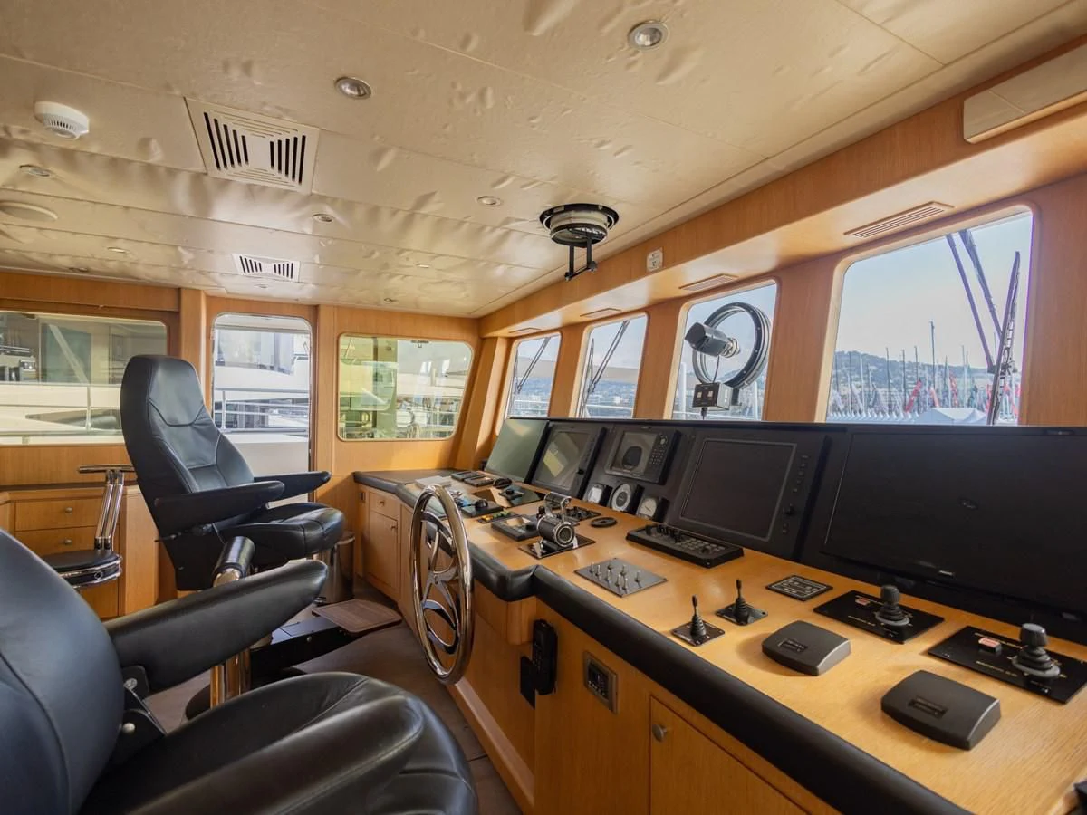 a room with a desk and chairs aboard BANDIDO I Yacht for Sale