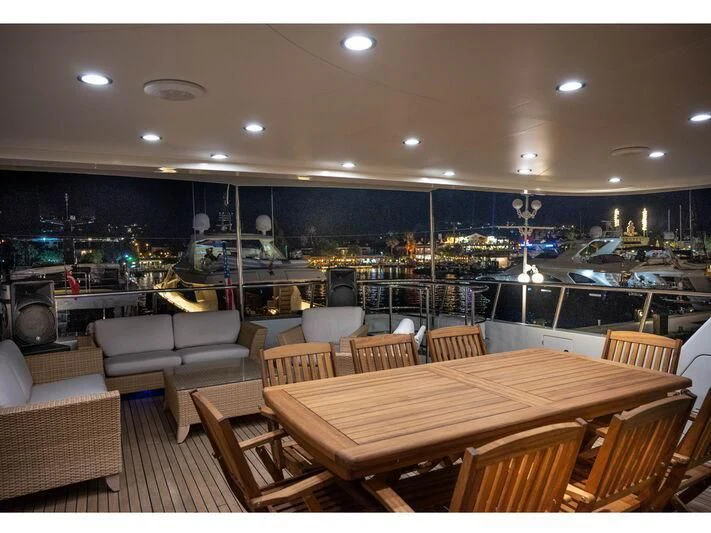 a large room with a table and chairs aboard BANDIDO I Yacht for Sale