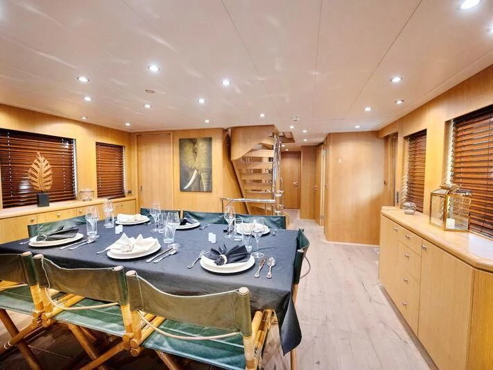 a large kitchen with a dining table aboard BANDIDO I Yacht for Sale