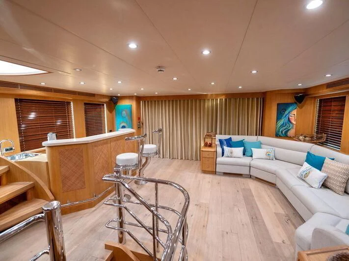 a living room with a balcony aboard BANDIDO I Yacht for Sale