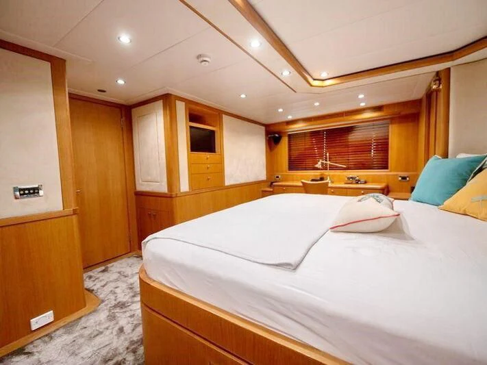 a room with a bed and cabinets aboard BANDIDO I Yacht for Sale