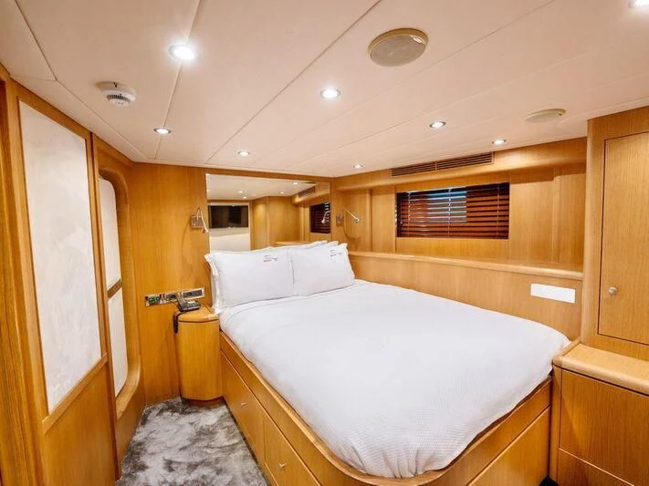 a bedroom with a bed and a window aboard BANDIDO I Yacht for Sale