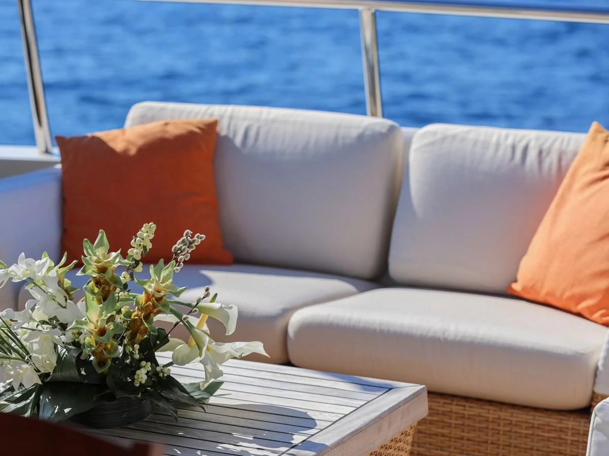 a white couch with orange pillows aboard BANDIDO I Yacht for Sale