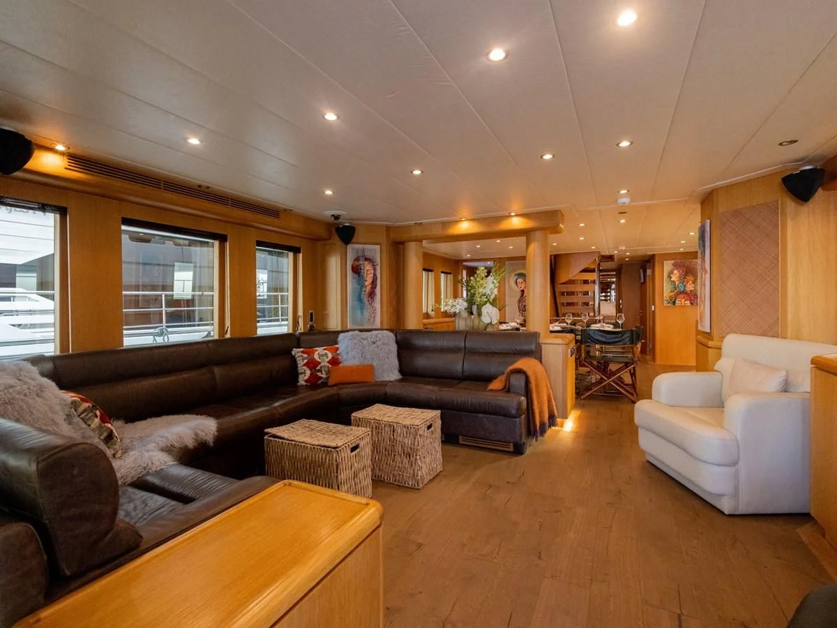 a living room with leather couches aboard BANDIDO I Yacht for Sale