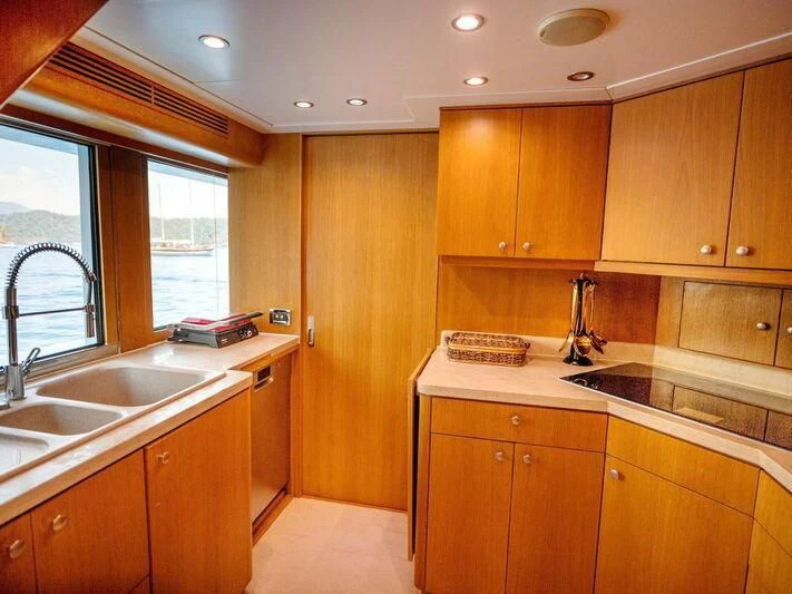 a kitchen with wooden cabinets aboard BANDIDO I Yacht for Sale