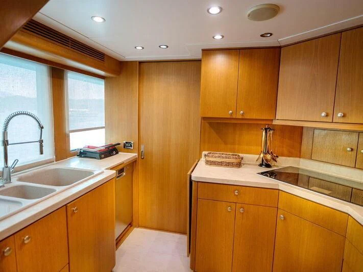 a kitchen with wooden cabinets aboard BANDIDO I Yacht for Sale
