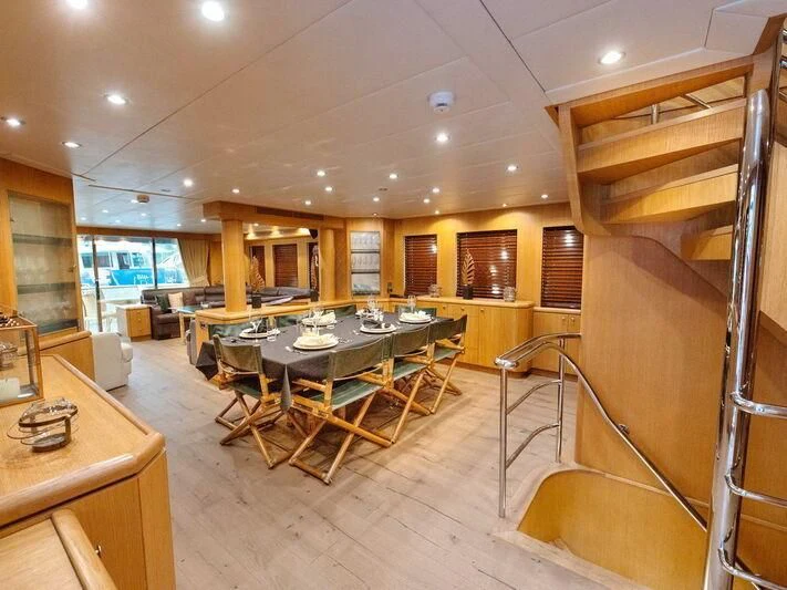 a room with a table and chairs aboard BANDIDO I Yacht for Sale