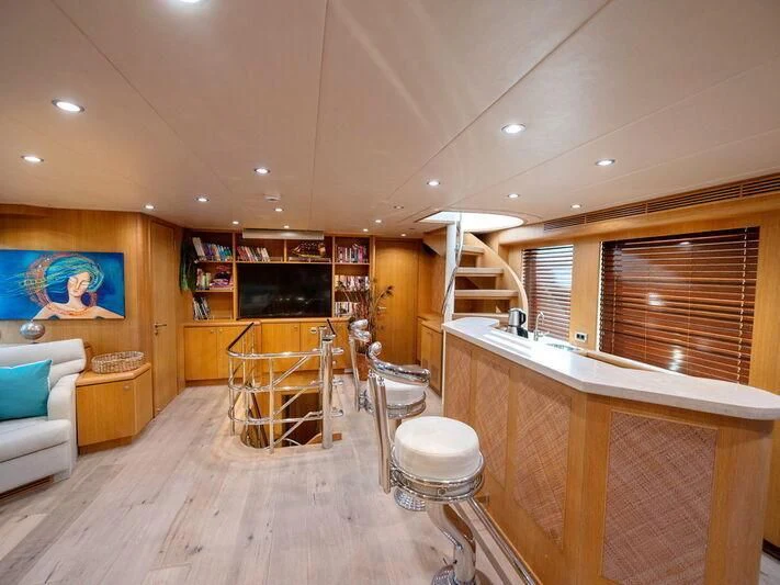 a room with a wood floor and a wood floor and a large window aboard BANDIDO I Yacht for Sale