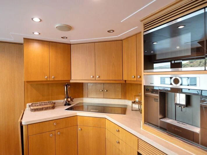 a kitchen with wooden cabinets aboard BANDIDO I Yacht for Sale