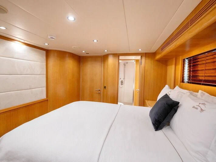 a room with a bed and a window aboard BANDIDO I Yacht for Sale