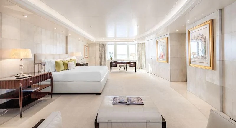 a large room with a bed and a table aboard FELIX Yacht for Sale