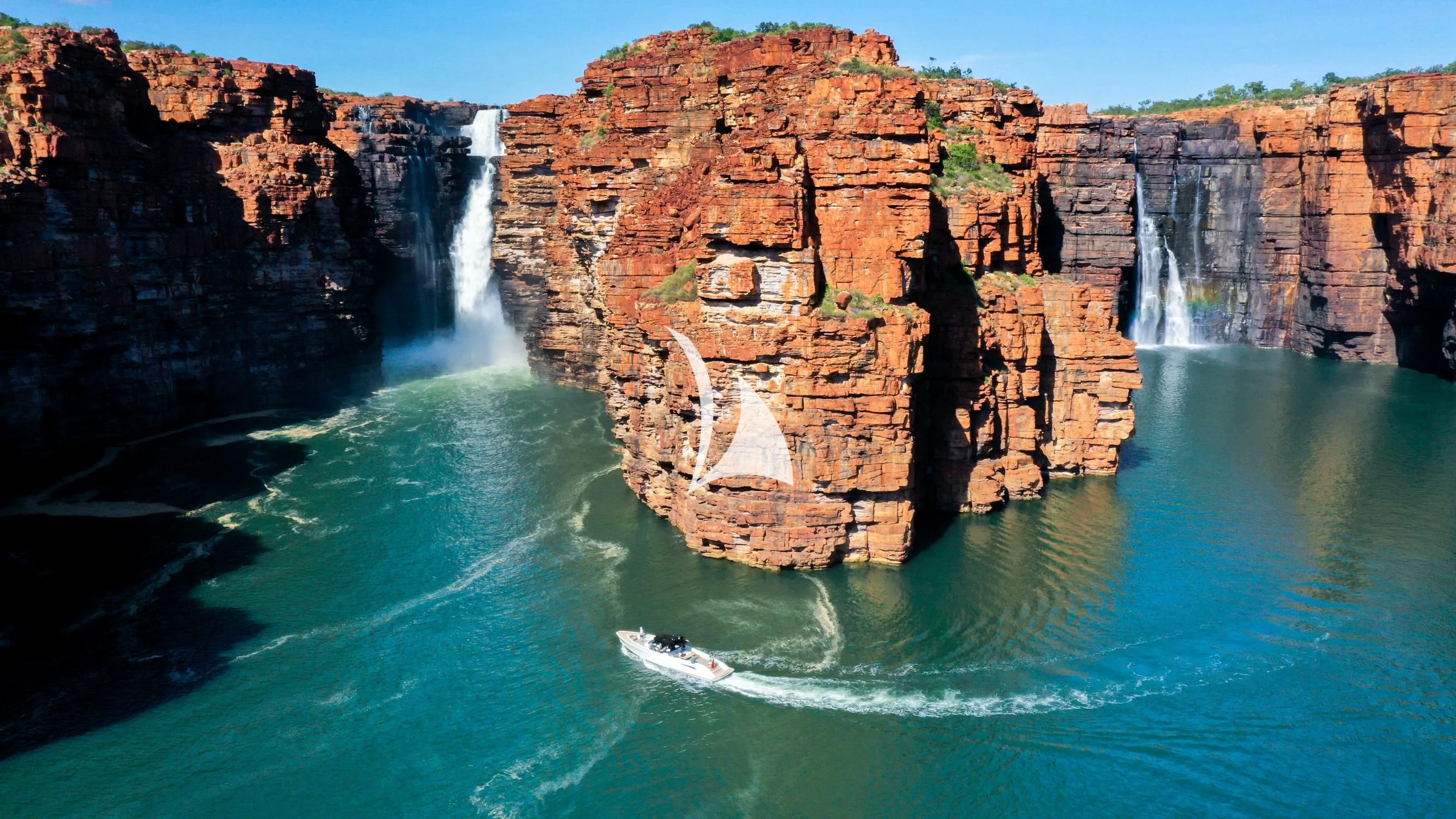 a cliff with a waterfall aboard FELIX Yacht for Sale