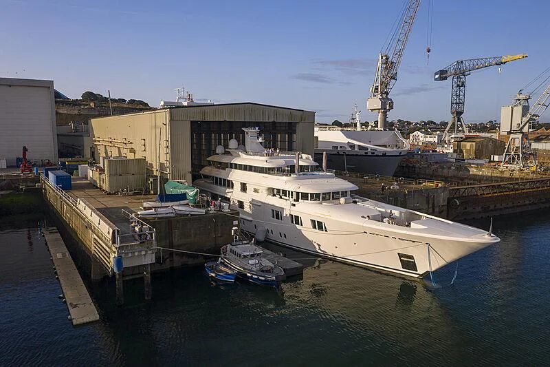 a large white boat docked at a port aboard FELIX Yacht for Sale