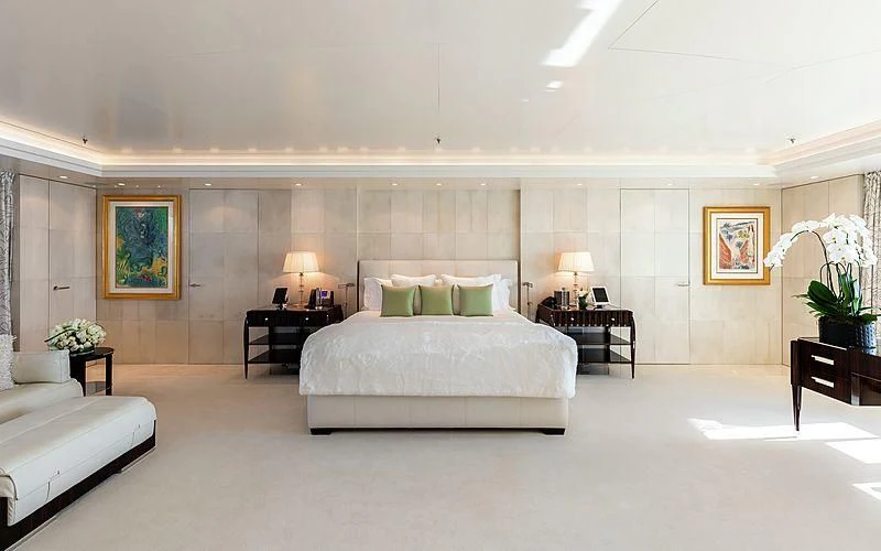 a large room with a bed and a table aboard FELIX Yacht for Sale