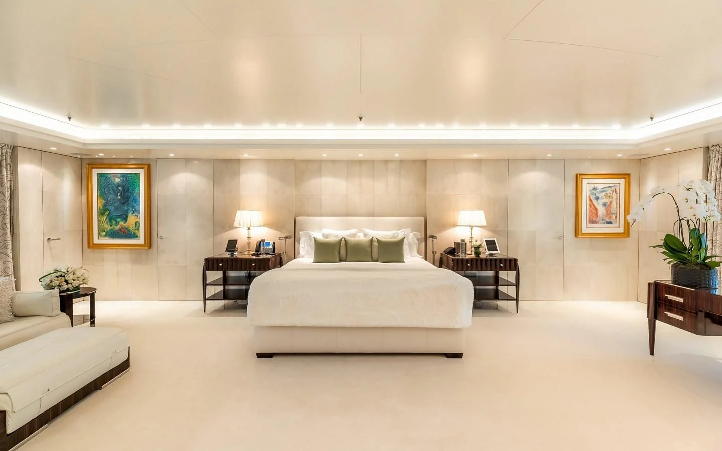 a large bedroom with a bed and a table aboard FELIX Yacht for Sale