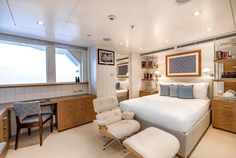 a bedroom with a bed and a desk aboard FELIX Yacht for Sale