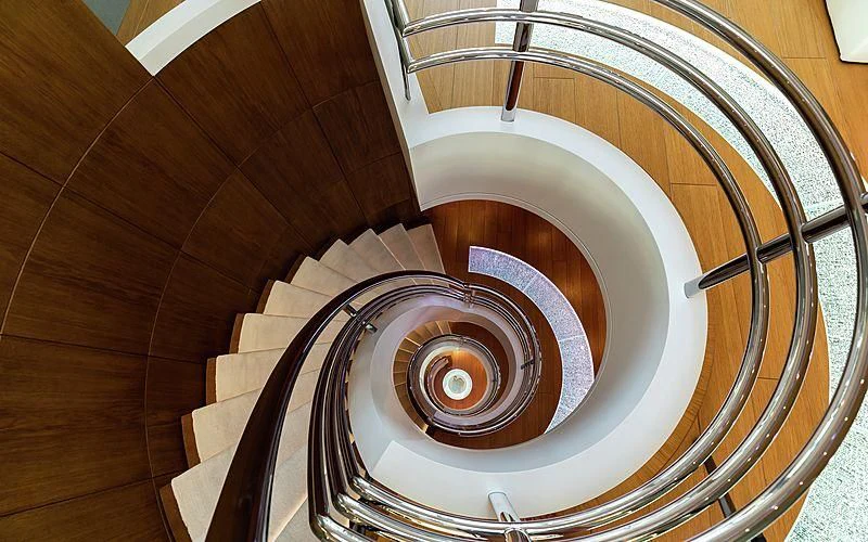 a spiral staircase with a spiral staircase aboard FELIX Yacht for Sale