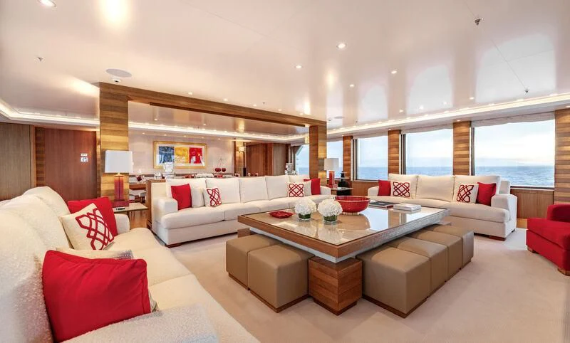 a living room with a table and couches aboard FELIX Yacht for Sale