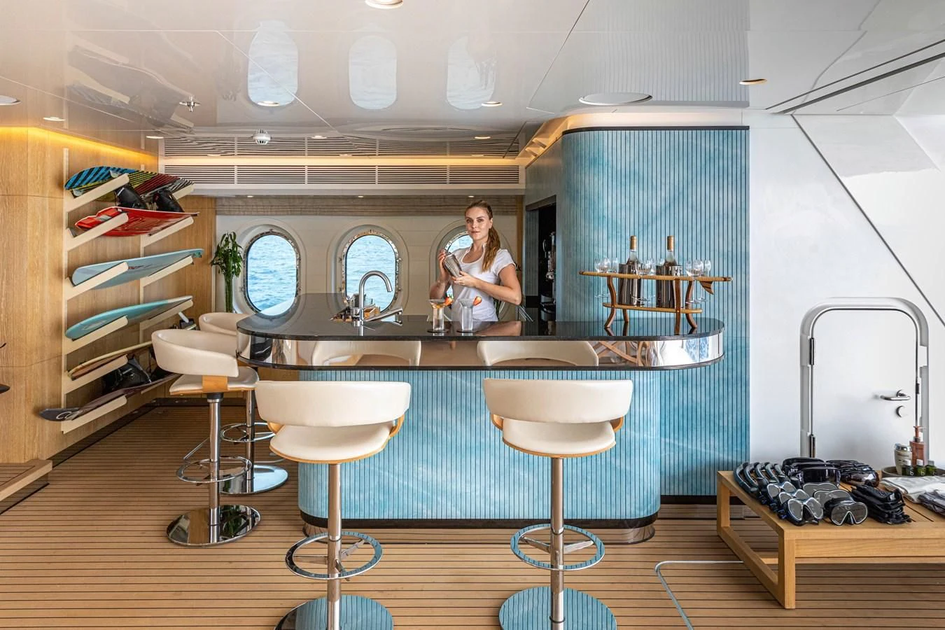 a person in a room with a counter and stools aboard FELIX Yacht for Sale