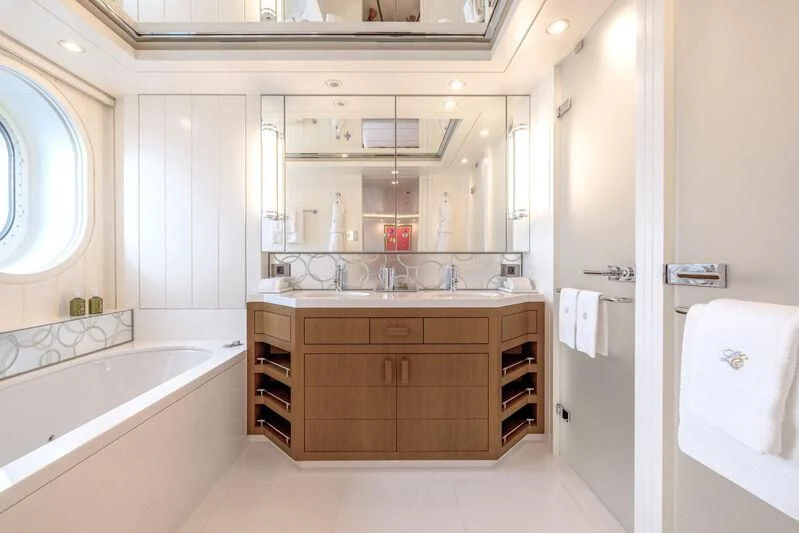 a bathroom with a large mirror aboard FELIX Yacht for Sale