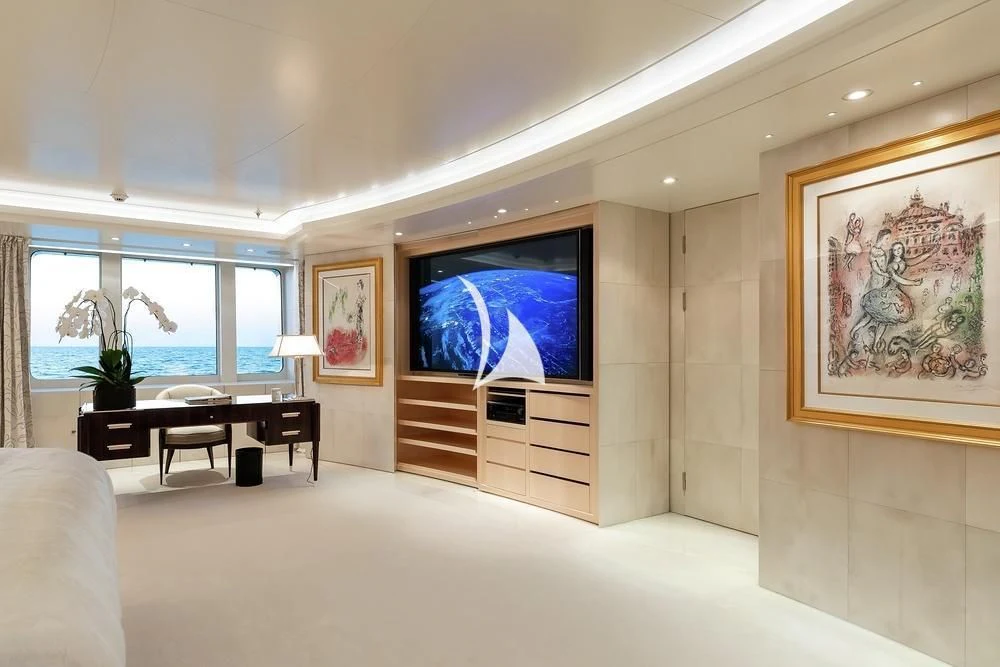 a room with a large television and a large window aboard FELIX Yacht for Sale
