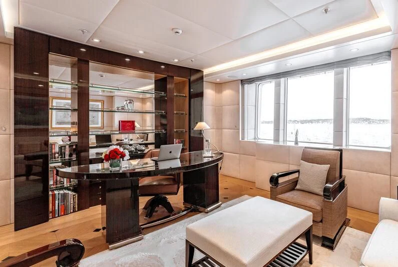 a room with a desk and a chair and a window aboard FELIX Yacht for Sale