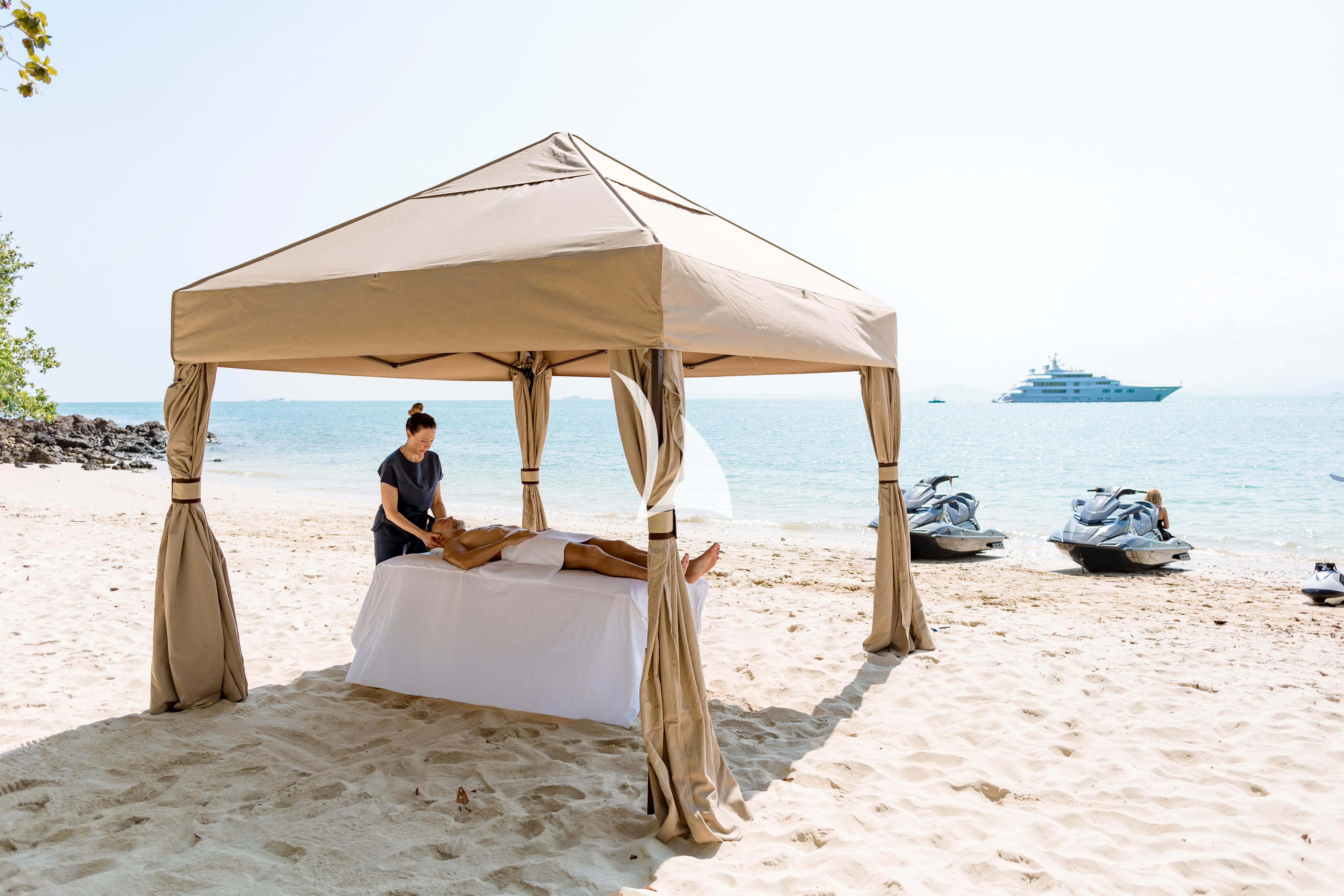a person sitting under a shelter on a beach aboard FELIX Yacht for Sale