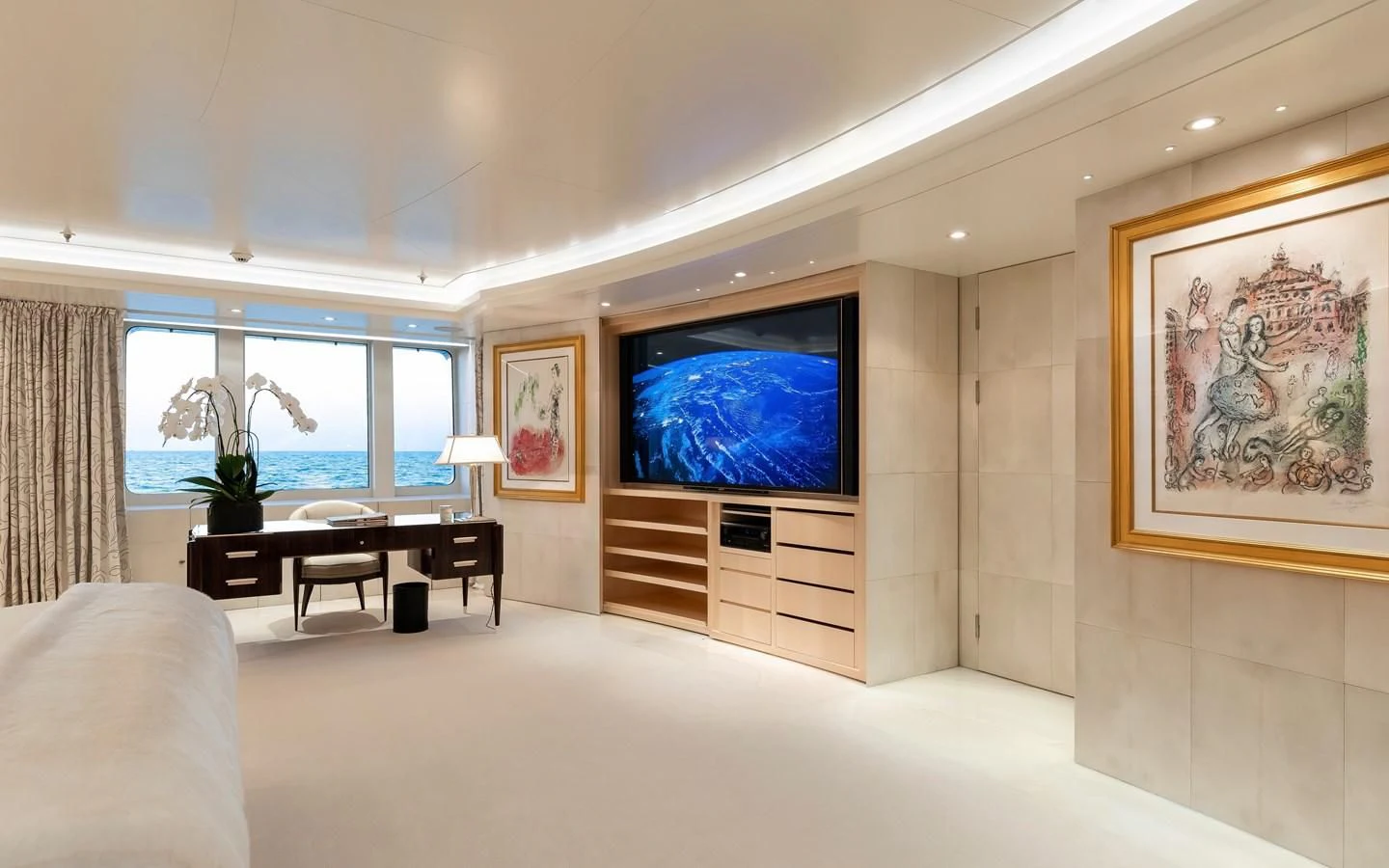 a large room with a tv and a table aboard FELIX Yacht for Sale