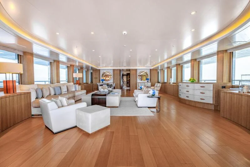 a large living room with white couches and a wood floor aboard FELIX Yacht for Sale