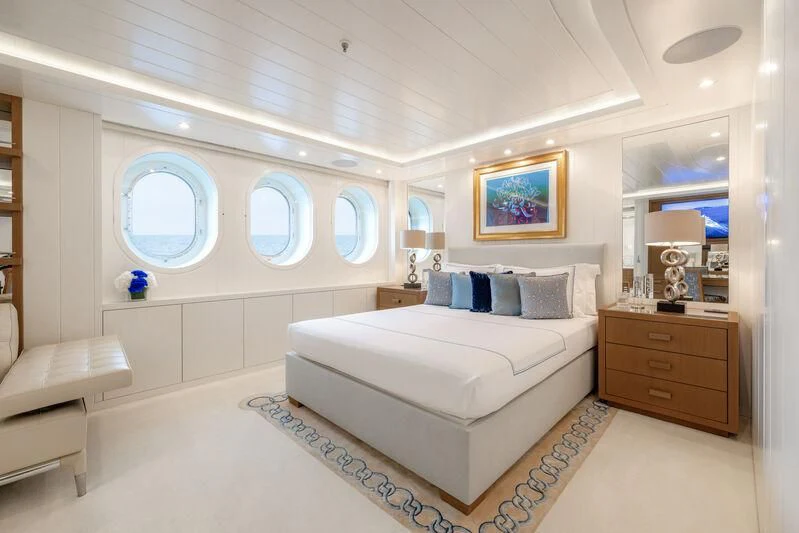 a bedroom with a bed and a mirror aboard FELIX Yacht for Sale