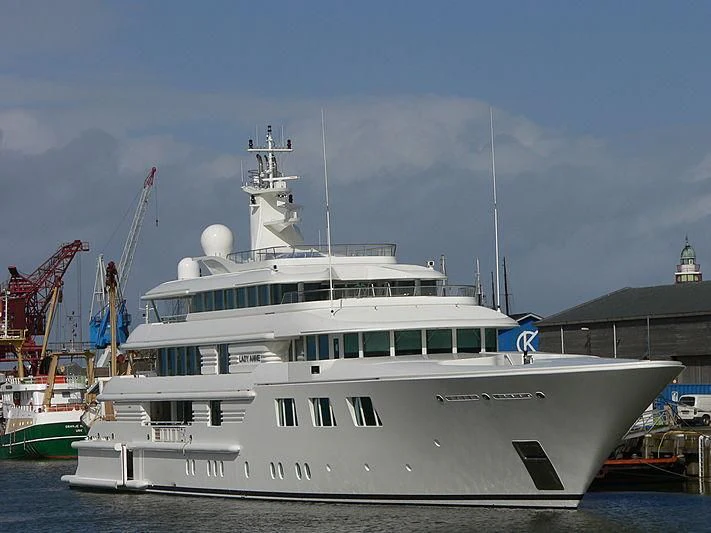 a large white boat in a harbor aboard FELIX Yacht for Sale