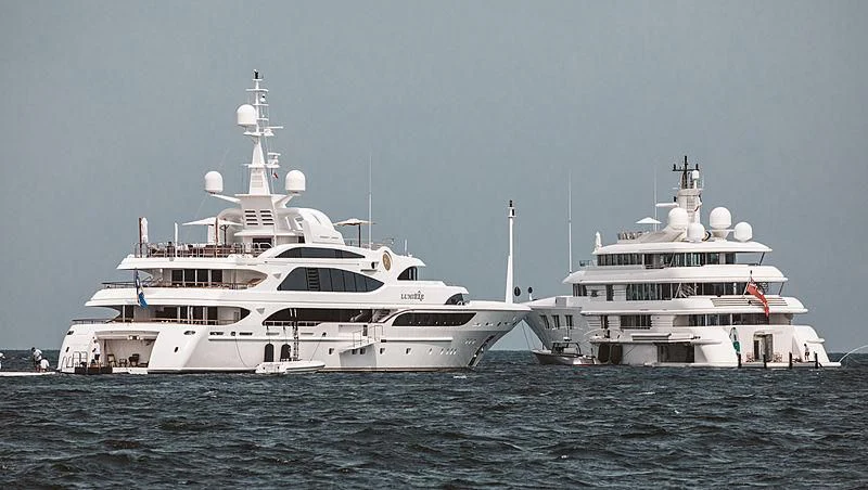 a couple of large white boats in the water aboard FELIX Yacht for Sale