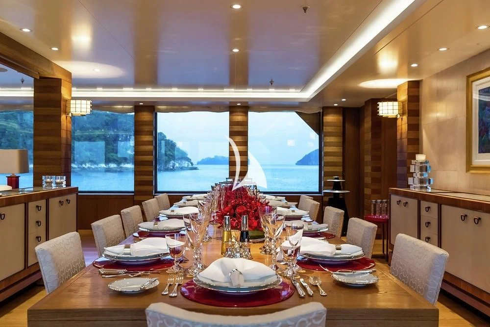 a dining room with a large window aboard FELIX Yacht for Sale