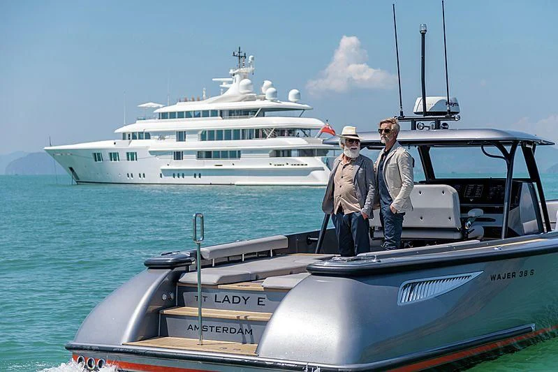 a couple of men standing on a boat in the water aboard FELIX Yacht for Sale